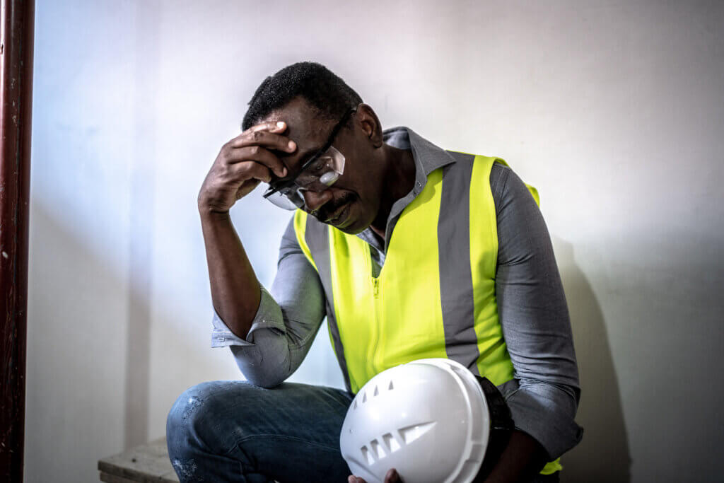 depressed construction worker at construction site